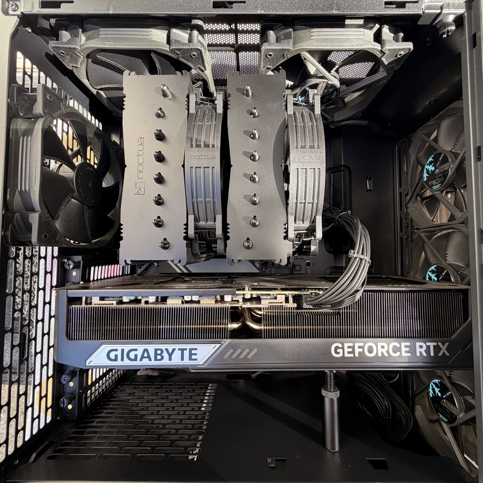 Interior of a custom-built desktop PC with a GeForce RTX graphics card and Noctua cooling